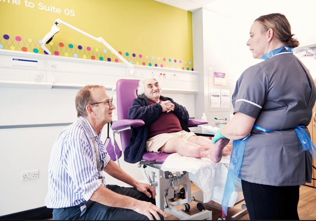 clinician and patient having leg ulcer treatment at the Acclerate centre for exellence in Hackney, London