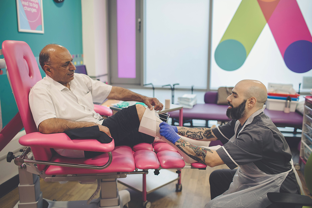 Male nurse bandaging patient in Accelerate treatment room