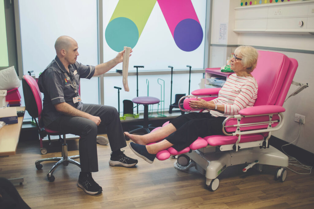Clinician with patient at Accelerate Cinic discussing hosiery